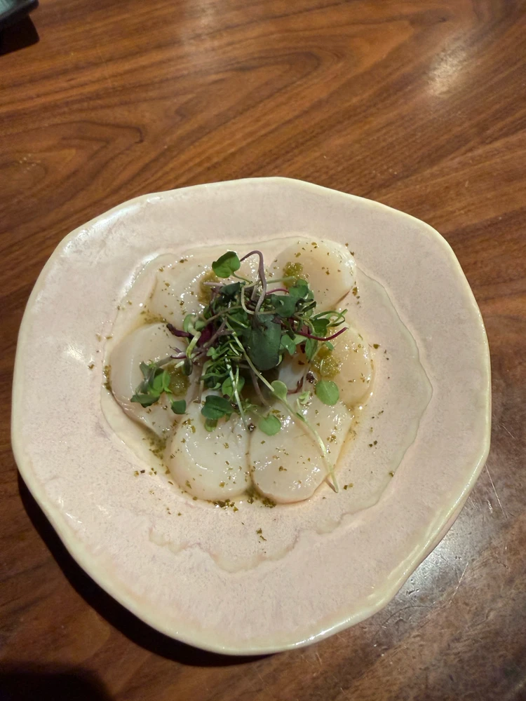 Fresh scallop sashimi w/ radish sprouts and bathed in yuzu kosho sauce