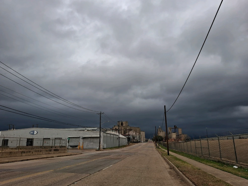 Some Street nearby some industrial buildings.