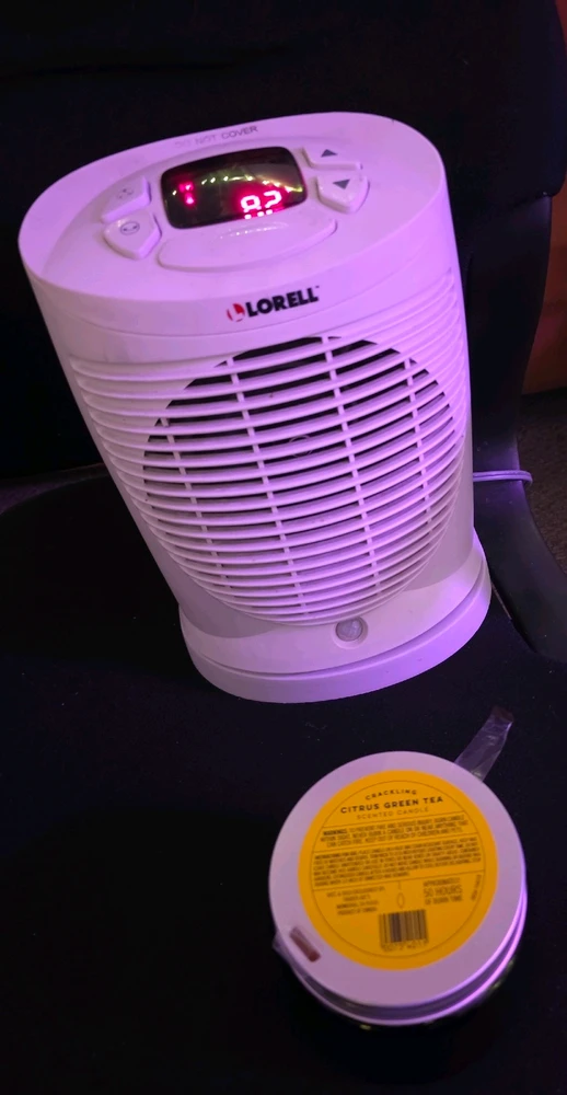 Space Heater on a candle with lid close to circulate wax aroma