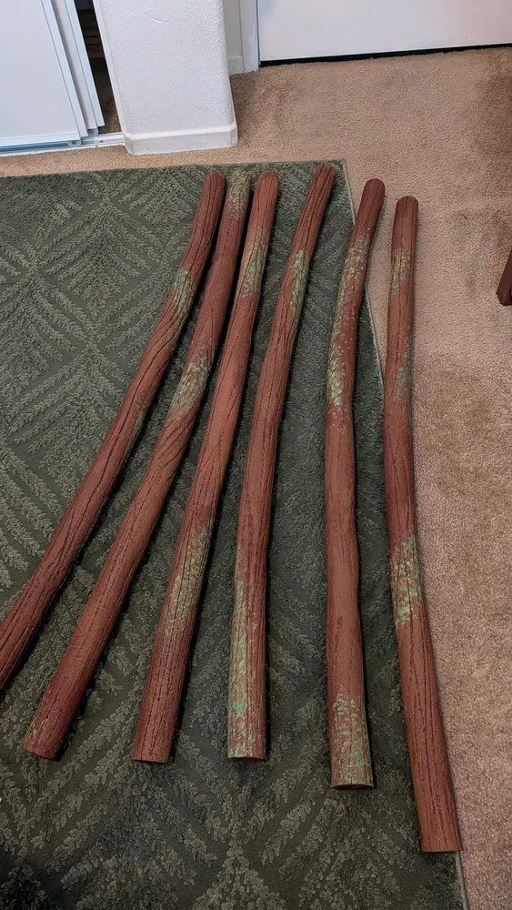 Pool noodles painted to look like logs with moss