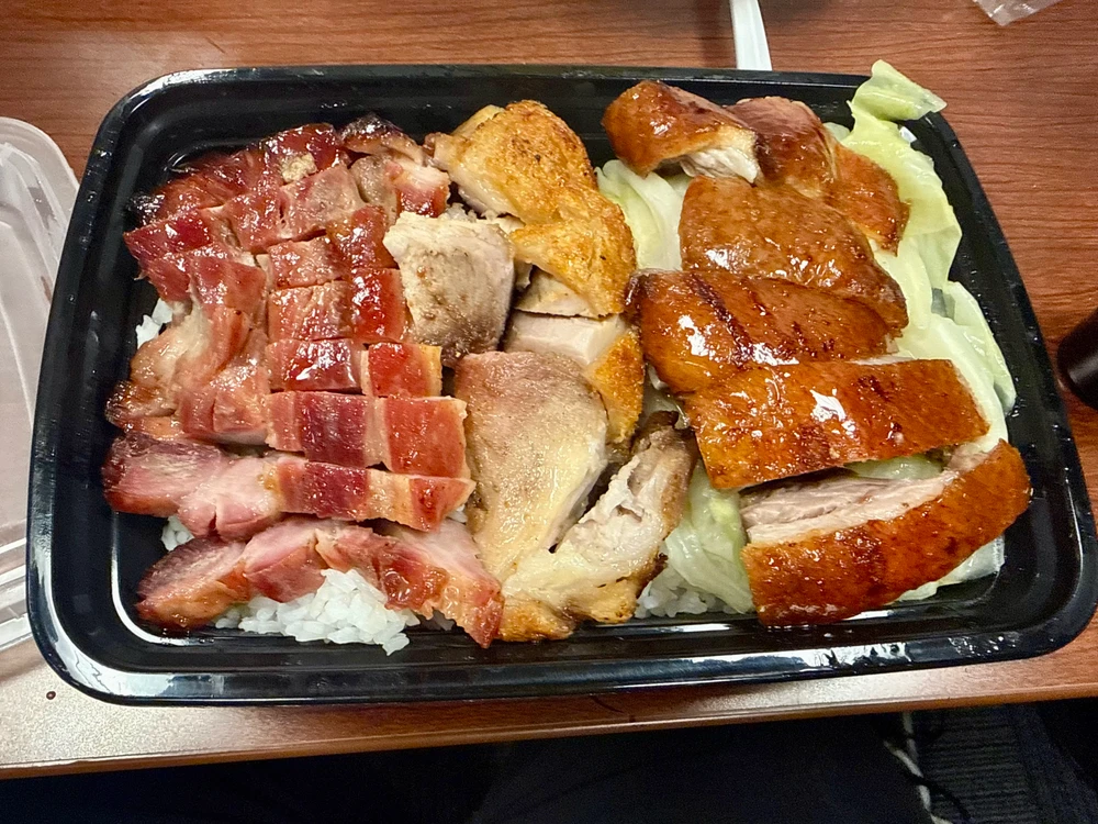 Char Siu, Crispy Pork, and Roasted Duck. over rice and a little cabbage. 