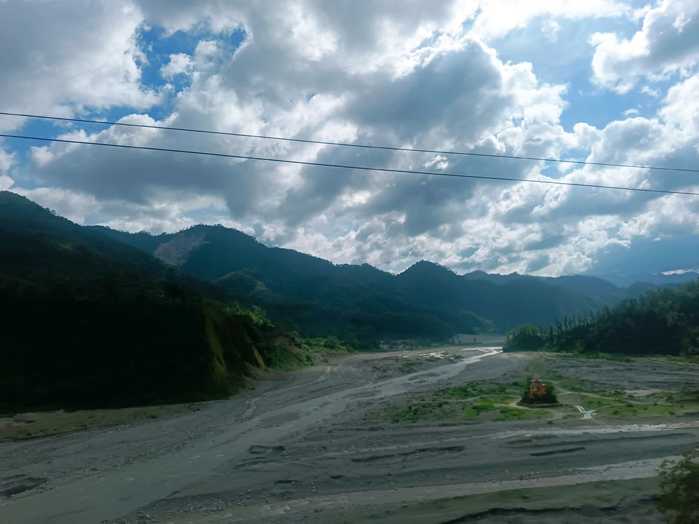 River bank surrounded by mountains.