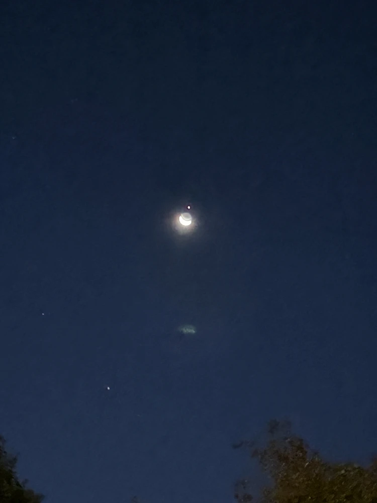 Jupiter just coming out from behind the Moon. 